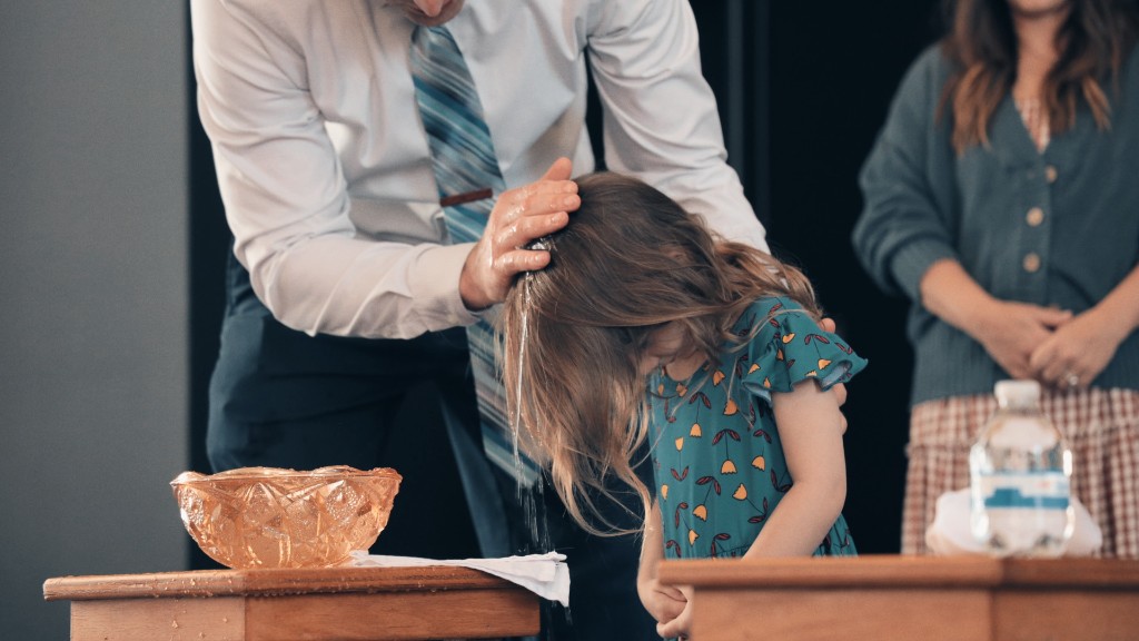 A young child receiving baptism by water during a CCLC worship service
